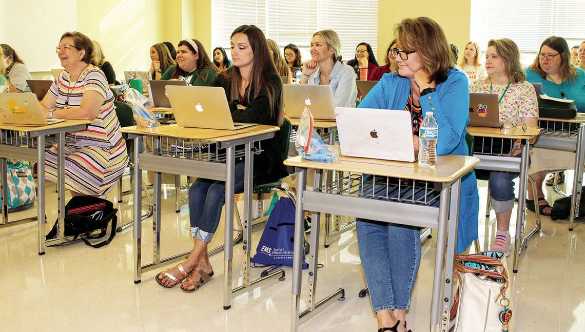 Taylor educators are all smiles as they begin professional development sessions to prepare for a successful year. Photo by Tim Crow