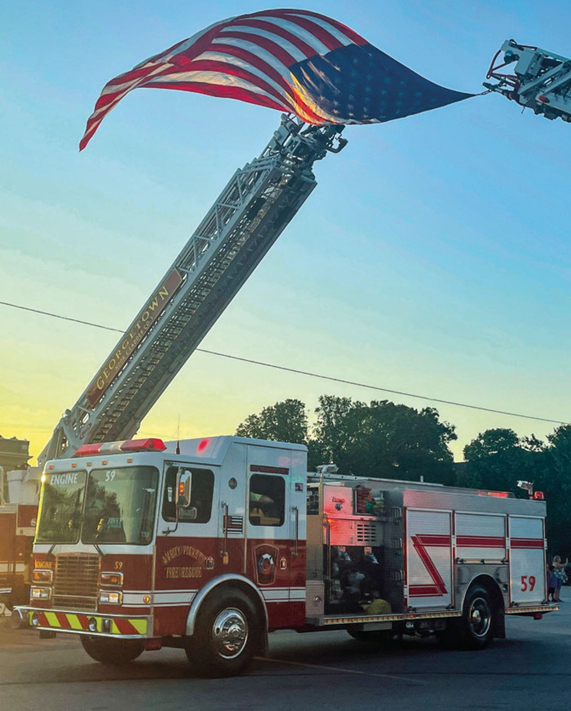 The American waves in the air of downtown Taylor as first responders line up to march in remembrance of the tragic events of Sept. 11, 2001. Photo by Fernando Castro