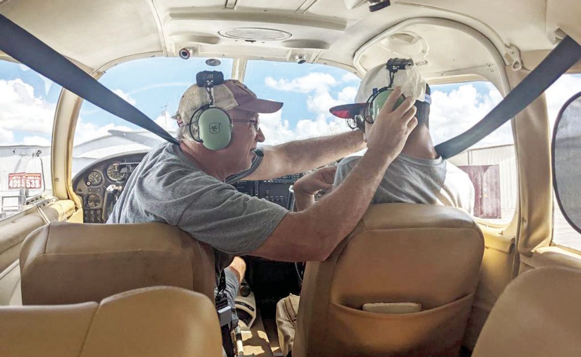 Volunteer Pilot Scott Bounds adjusts Emiliano Gonzalez’s headsets as he prepares to fly an airplane at the Flying Vikings event Sept. 17. Courtesy photos