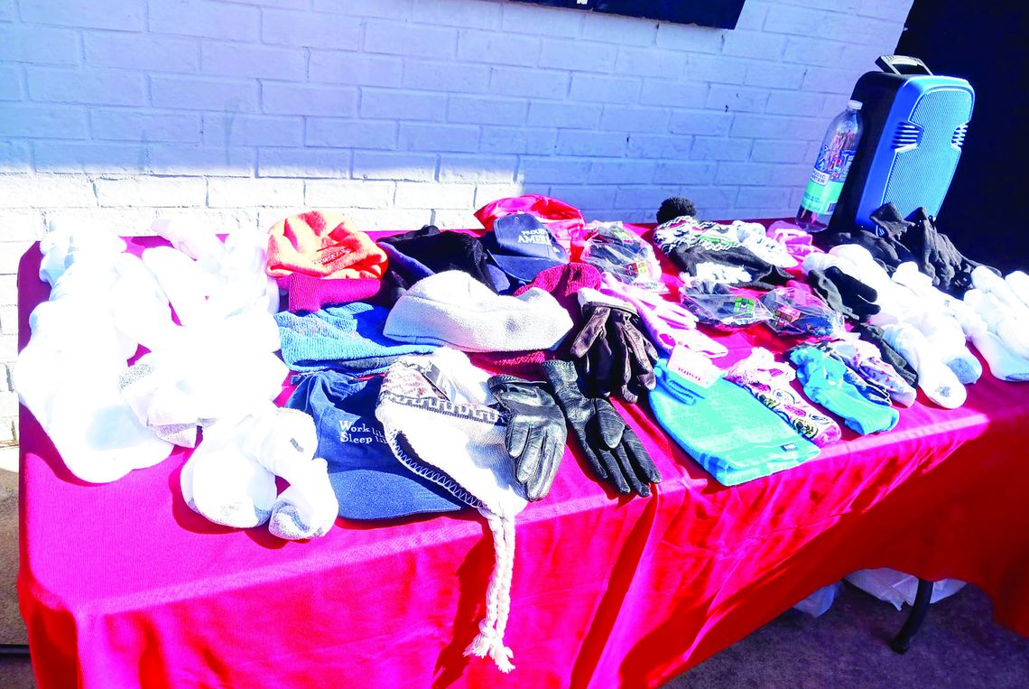 Assorted gloves, hats and other cold-weather gear is displayed at a Winter Coat Give Away Dec. 17, sponsored by the local restaurant Seed to Soul Food and 10,000 Fearless First Responders. Photo by Nicole Lessin