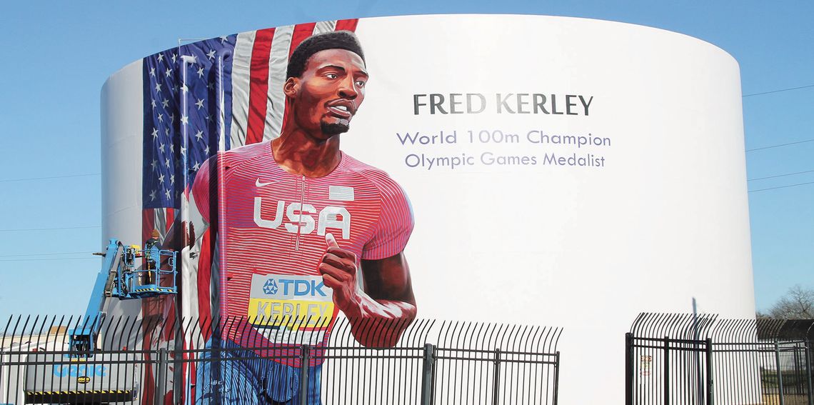 Fred Kerley’s mural being painted by local artist Adam Davenport at 1606 Main St. Photo by Nicole Lessin