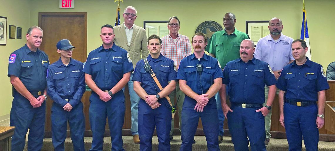 Chief Daniel Baum (right) talks about the heroic efforts of Taylor Fire Department firefighters who worked as a team to complete a dramatic ladder rescue and extinguish a dangerous fire at the Burnett Place Apartments June 5, including Assistant Chief Robert Copeland (left), Lt. Eric Engel...