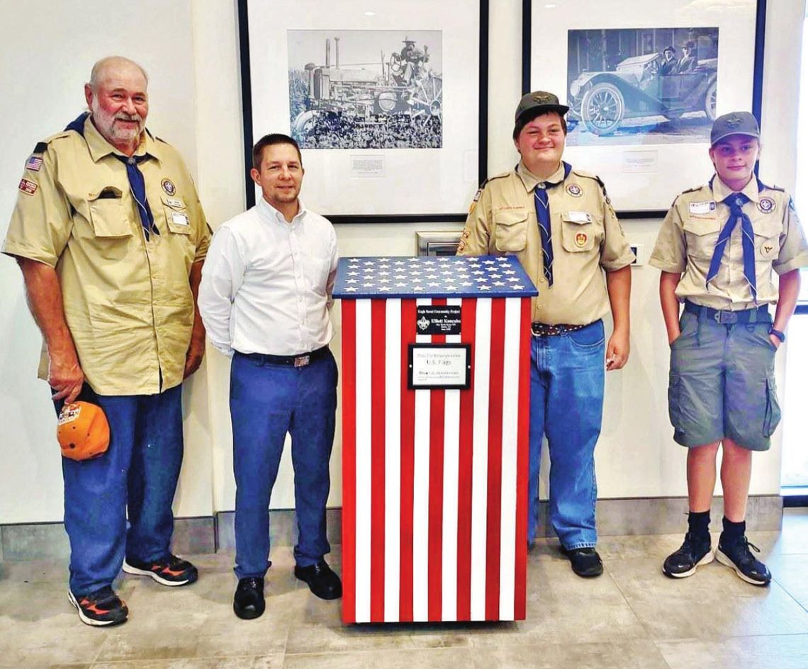 Elliott Koncaba and others stand beside one of the flag retirement boxes throughout Hutto. Courtesy photo / City of Hutto