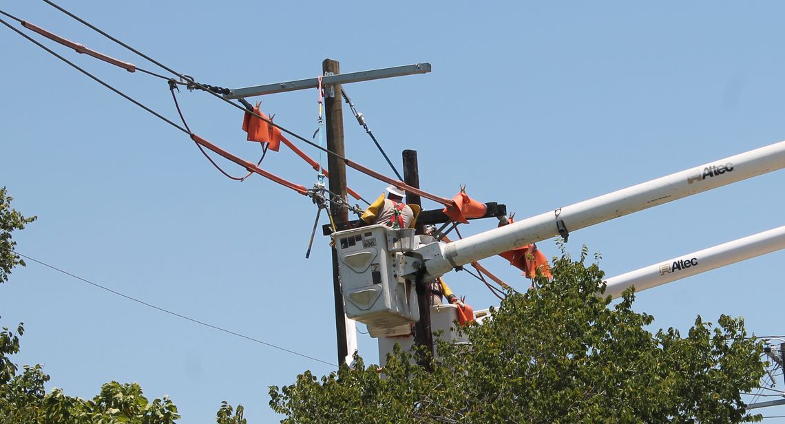 A utility worker works on a power line pole on Lake Drive in Taylor July 24, 2020.