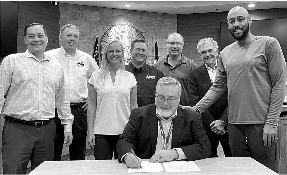 City Manager James Earp, seated, signs Cottonwood Properties ownership over to the EDC. Left to right: EDC board members Shawn Lucas, Mike Snyder, Erin Clancy and Randal Clark. Cottonwood Development Corporation member Peter Gordon. Director of Economic Development Bob Farley. EDC board me...