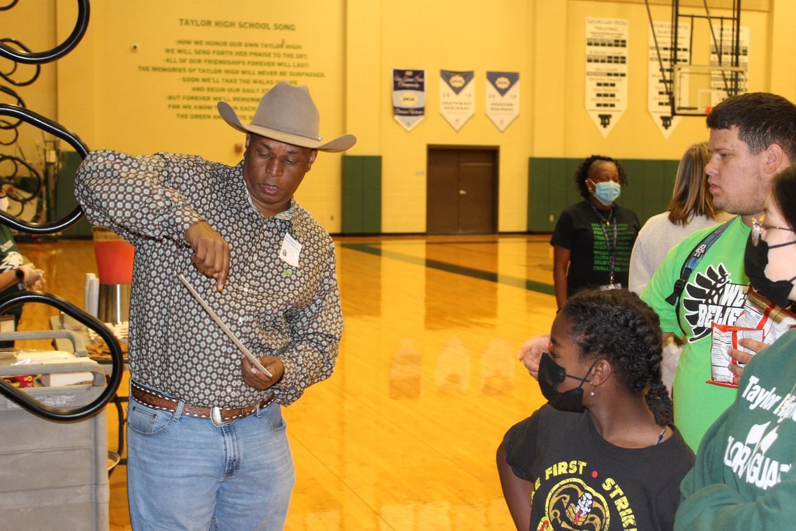 Councilman Gerald Anderson talks with Taylor High School students about Cowboy Bill Pickett. Photos by Tim Crow