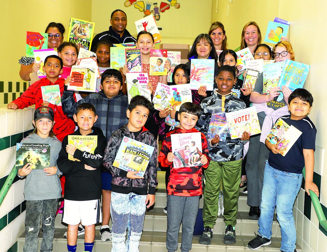 Employees at FedEx Ground Pflugerville held a book drive, donating 366 books to Taylor ISD. These books will be distributed to elementary students to support summer reading. FedEx representatives Jean Tate and Jabari Williams are shown presenting the books to Naomi Pasemann Elementary stud...