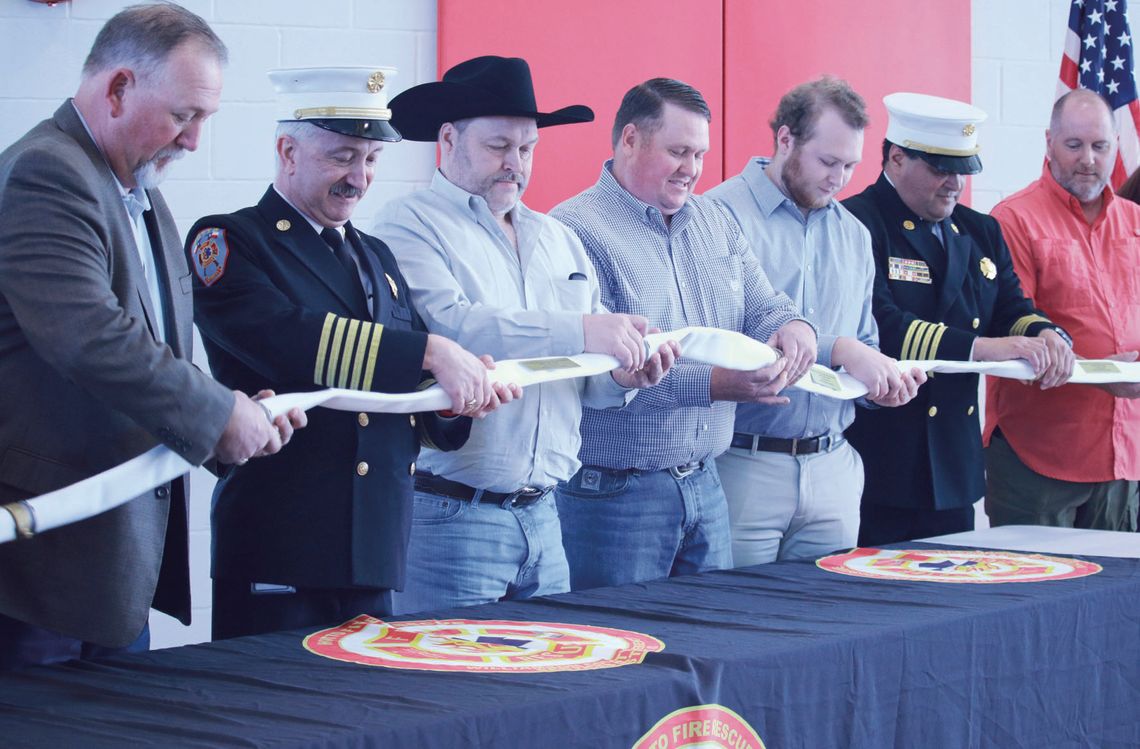 WCESD No. 3 commissioner Bill Brown, Fire Chief Scott Kerwood, Shawn Oman, Troy Oman, Marshall Oman, Assistant Fire Chief Rob Bocanegra and Erick Burns of Trimbuilt Construction work at uncoupling the commemorative hose sections along with (not pictured) architect Keith Hickman and WCESD #...