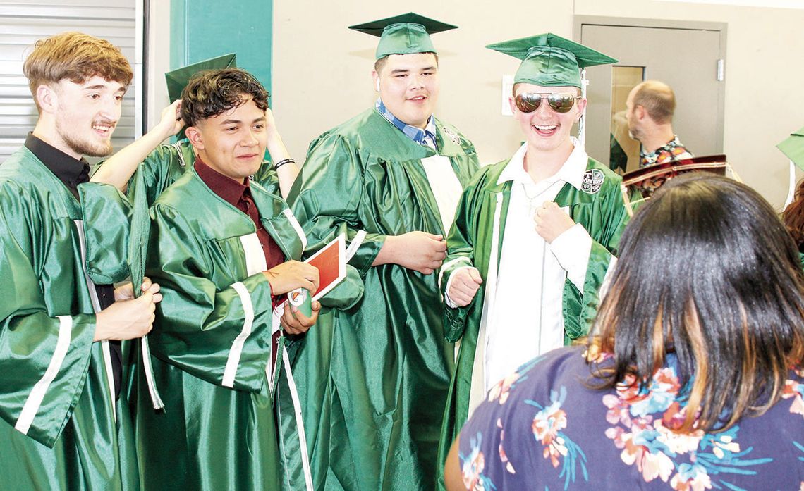 Hunter Crump (far right), showing the smile he was known for, poses for a photo at his graduation from Taylor High School in 2022. Photo by Tim Crow