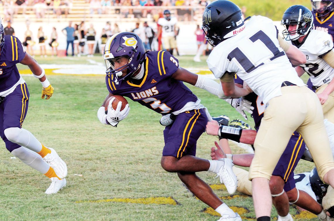 Granger High School varsity football senior running back Jayven Diaz breaks a tackle and runs for extra yardage on Aug. 25 during the Lions’ 57-8 blowout victory at home vs. Hubbard High School. Photo by Larry Pelchat