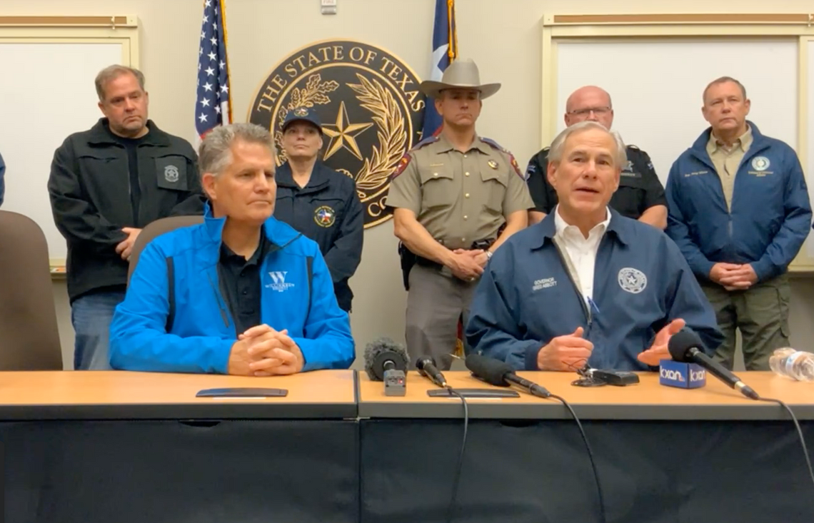 Gov. Greg Abbott (right) and Williamson County Judge Bill Gravell hold a press conference Monday, March 21, to update the community after storms in the county. Precinct 4 Commissioner Russ Boles (back, left) is also shown. Facebook / Williamson County Emergency Services