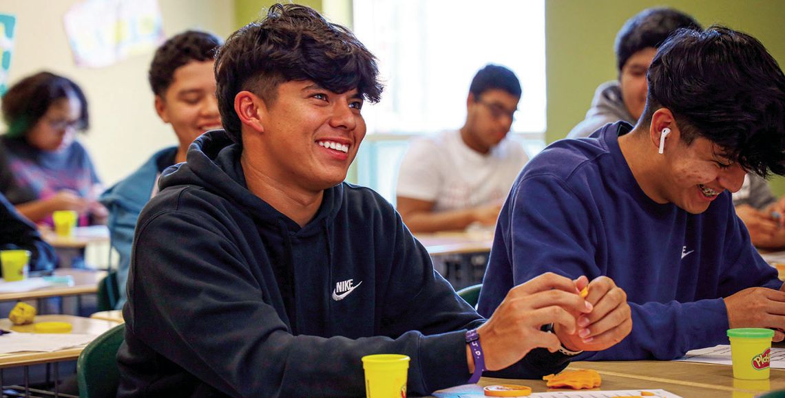 Ayden Gutierrez smiles big in Sarah Stresing’s geometry class at Taylor High School during a hands-on lesson using play-doh. Students used the familiar childhood toy to construct various lines and shapes. Photo by Ryan Newsom