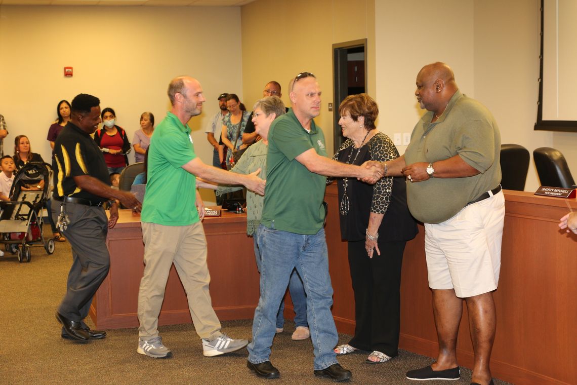 Carl Caldwell (left), soccer coach John Brockway (middle) and Dan Dixon are greeted with thanks and appreciation from the Taylor School Board for their quick actions and efforts in keeping the boys soccer team safe in their travels to a recent game. Photo by Tim Crow