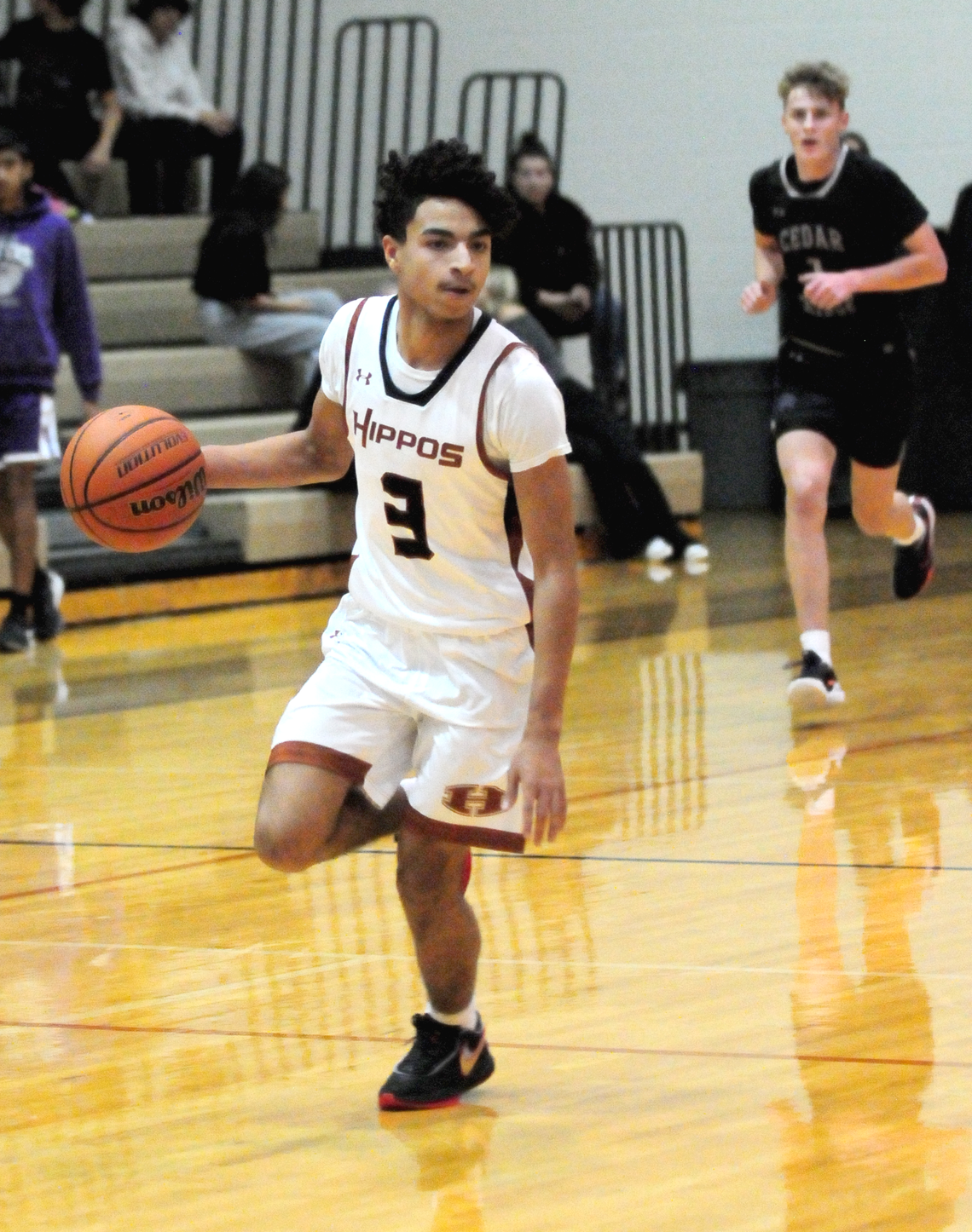 Hippos’ senior Jeremiah Washington speeding up the court on a fast break. Photo by Larry Pelchat