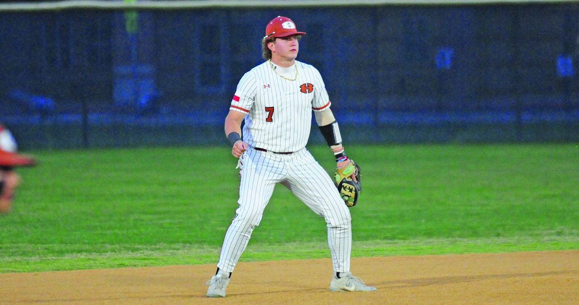 Garet Boehm getting into his defensive stance as the pitch is delivered. Photos by Larry Pelchat