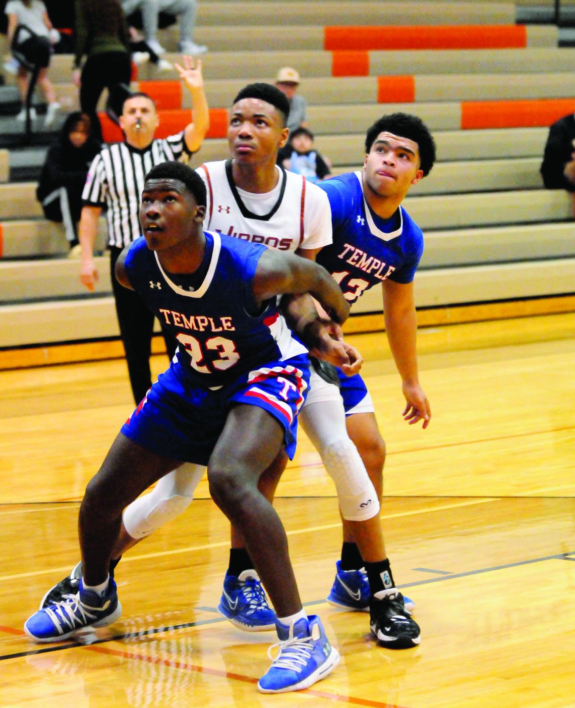 Hippos junior Zachary Hicks fighting off two defenders attempting to haul in a rebound. Photo by Larry Pelchat