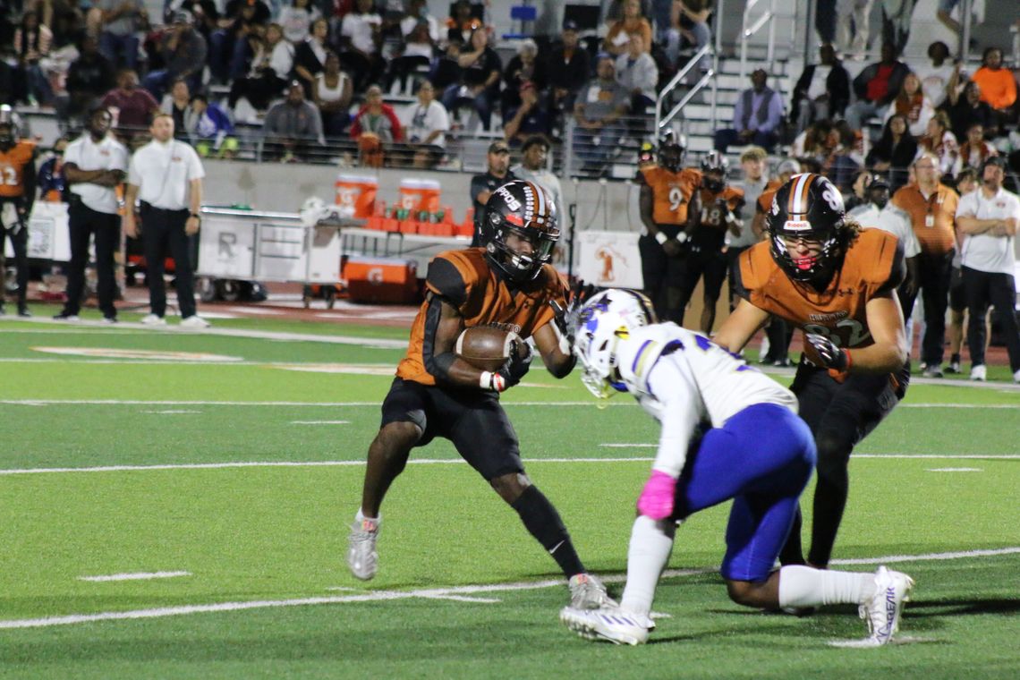 Hippos’ senior Gary Choice follows his blockers, but still braces for tackle from a Copperas Cove defender. Photo by Jason Hennington