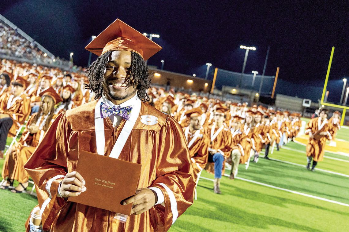 Jacob Bass smiles after he receives his diploma and his classmates line up to walk the stage. Photos courtesy of Hutto ISD Facebook page