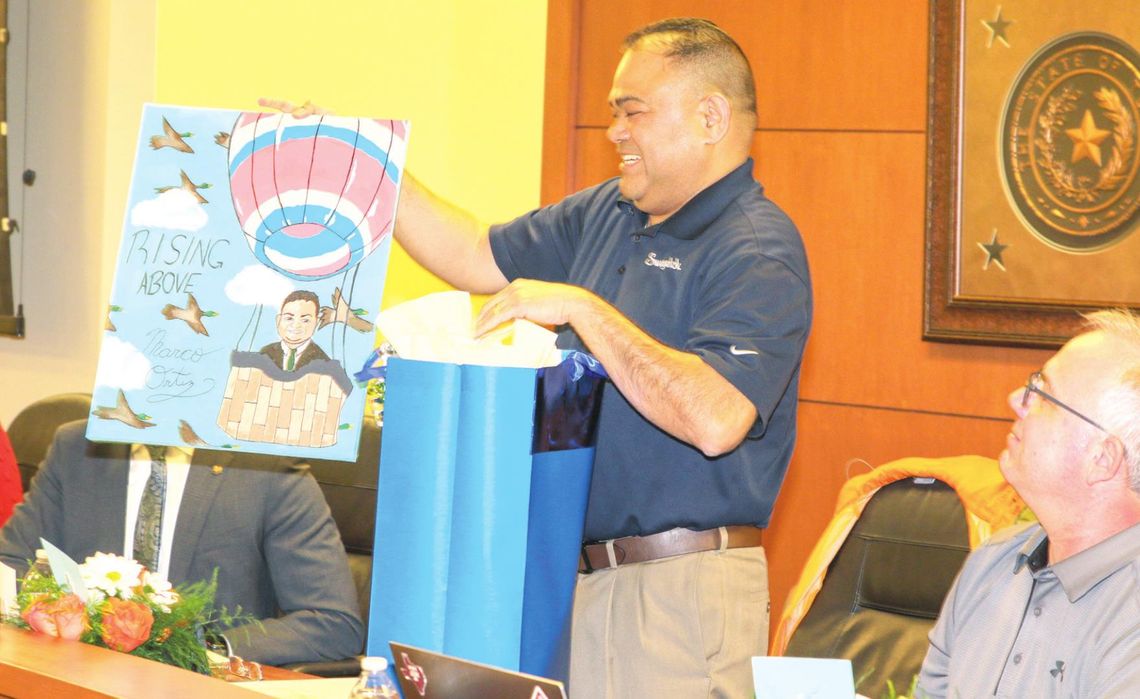 Taylor ISD school board president Marco Ortiz is presented with a personalized work of art from Legacy Early College High School during the school board meeting Jan. 24 in honor of his dedication and commitment to the Taylor schools. Photos by Tim Crow