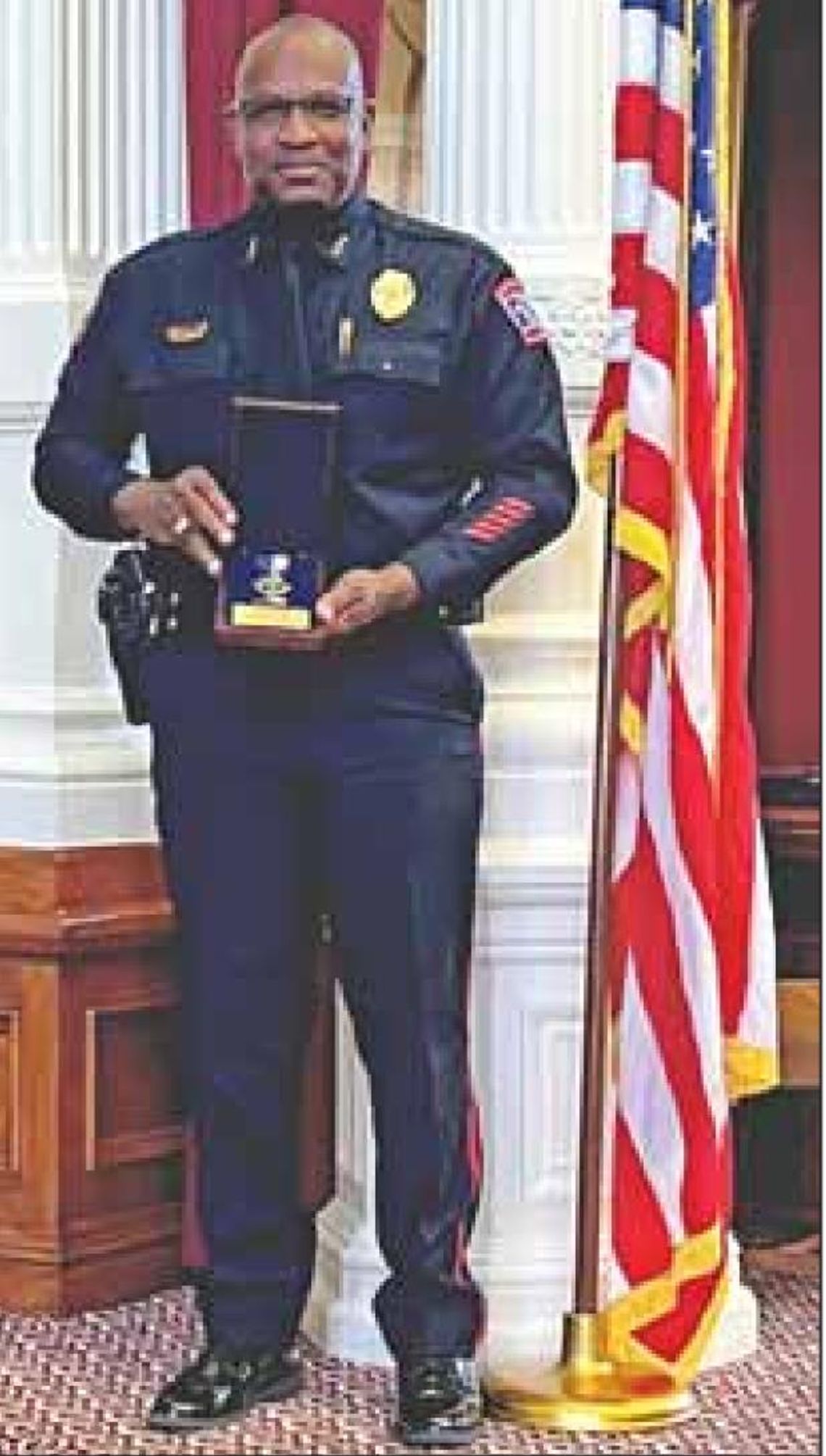 Chief Jeff Yarbrough stands with his 2022 Law Enforcement Award for Professional Achievement from the Texas Commission on Law Enforcement.