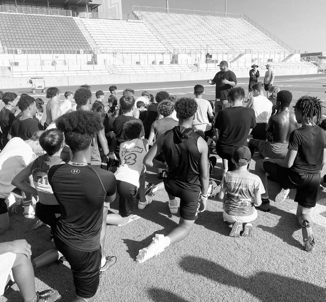 Lampe speaks to young Hippos football players on July 24 during the annual youth football camp held at Hutto Memorial Stadium. Photo courtesy of Will Compton