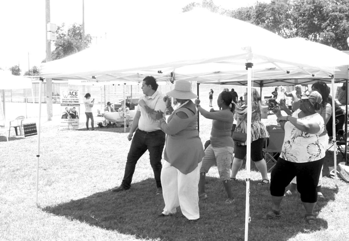 Visitors of the Juneteenth celebration do The Wobble at the May 2019 event at Fannie Robinson Park in Taylor. File photo