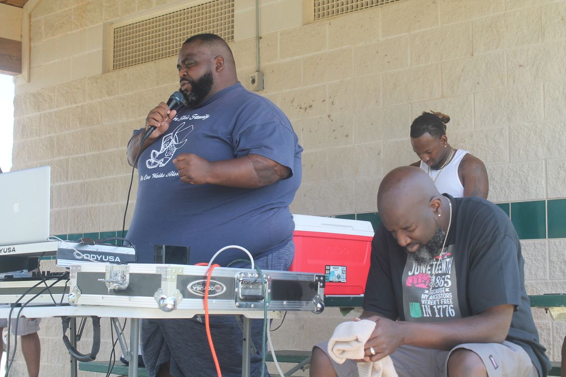 Quincy Sharp (left) leads in prayer during a Juneteenth celebration at Fannie Robinson Park in Taylor June 19, 2022. Photo by Fernando Castro