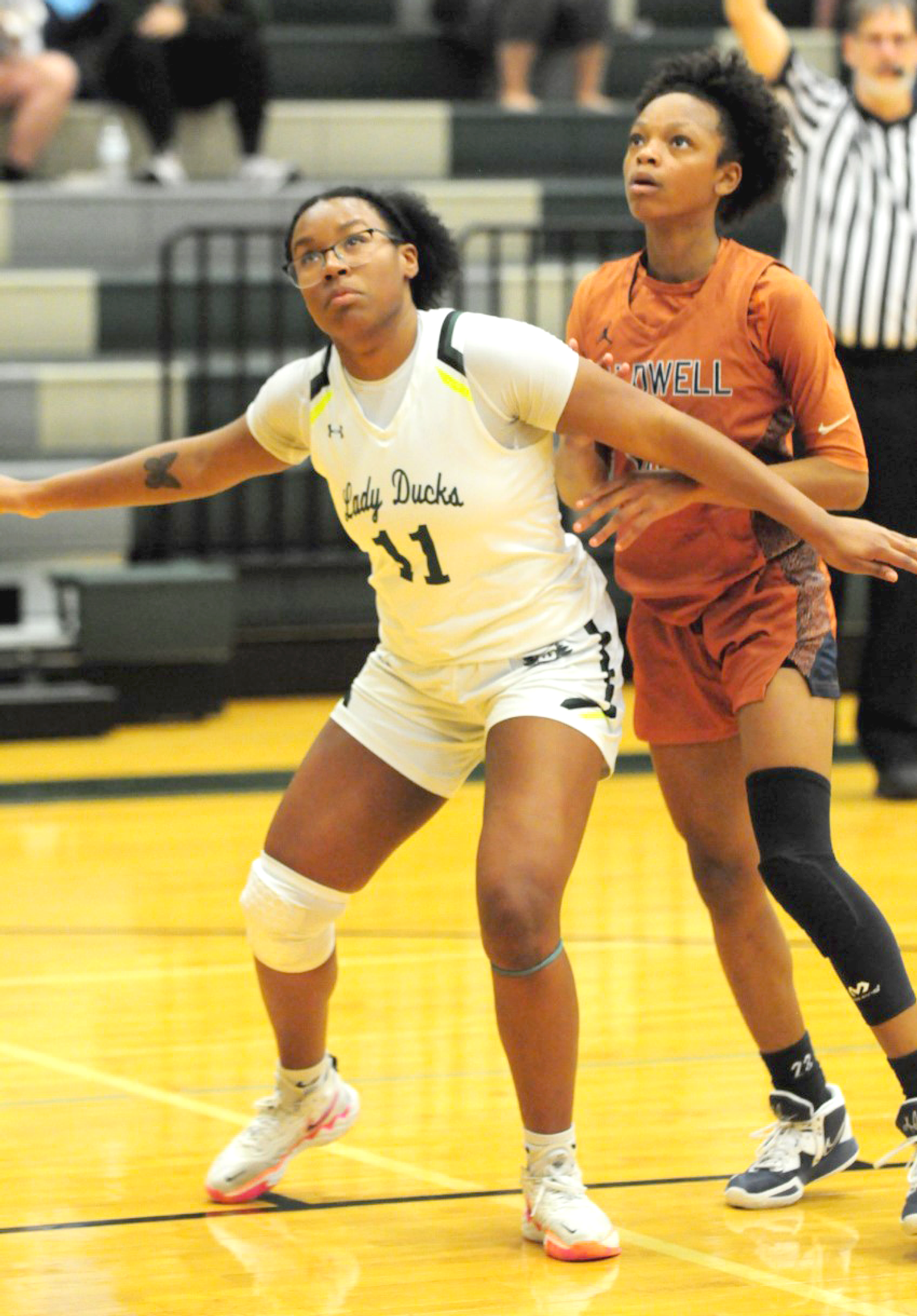 Lady Ducks senior Aliyana Chavis boxing out Caldwell senior guard Jae Mathis before grabbing a rebound. Photo by Larry Pelchat