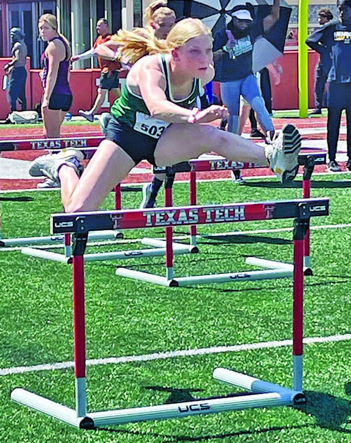 Lady Ducks senior Emma Whitsel jumping over a hurdle during her race on her way to second place. Courtesy Photo