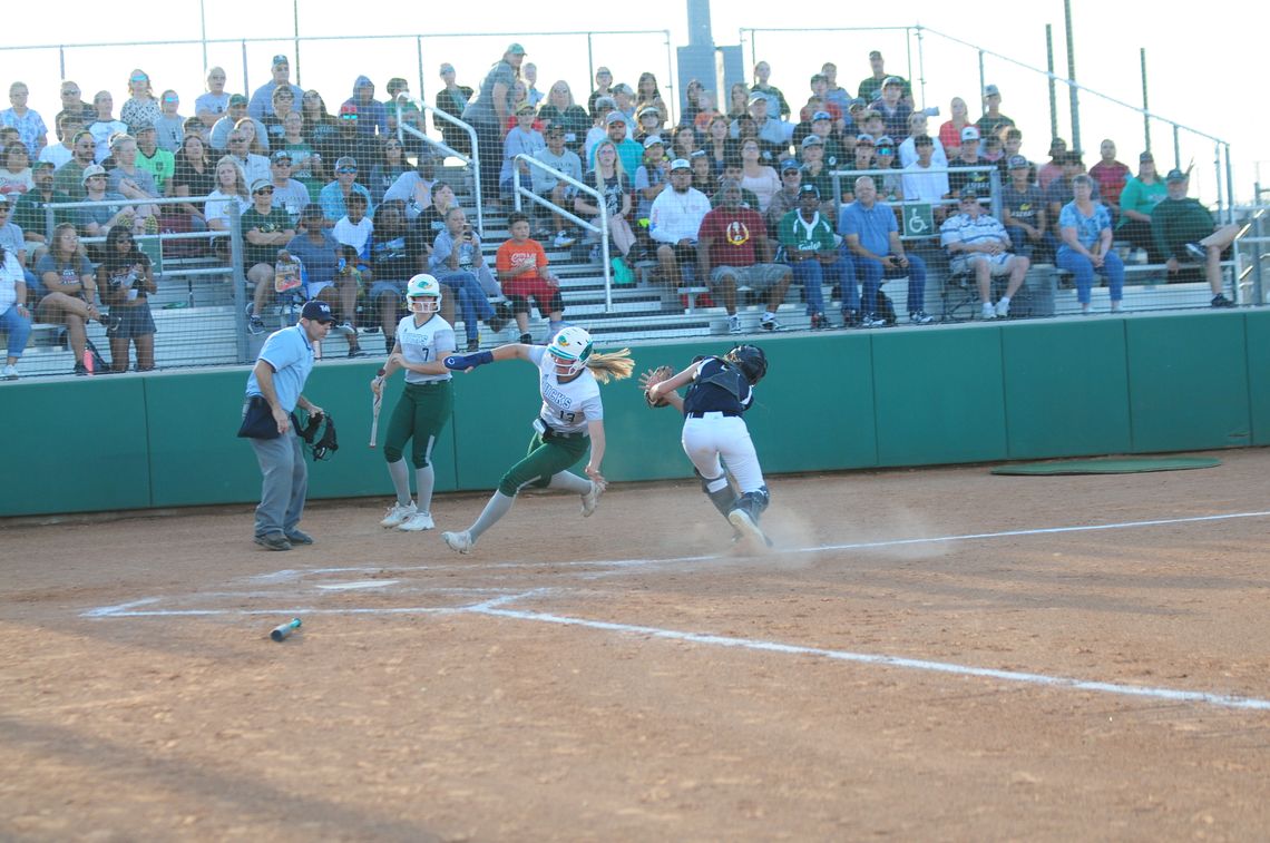 Lady Duck Mackenzie Watson eludes the Lady Buffs catcher during Taylor’s 10-0 stampeding win over Giddings last Thursday, April 28 at The Pond.