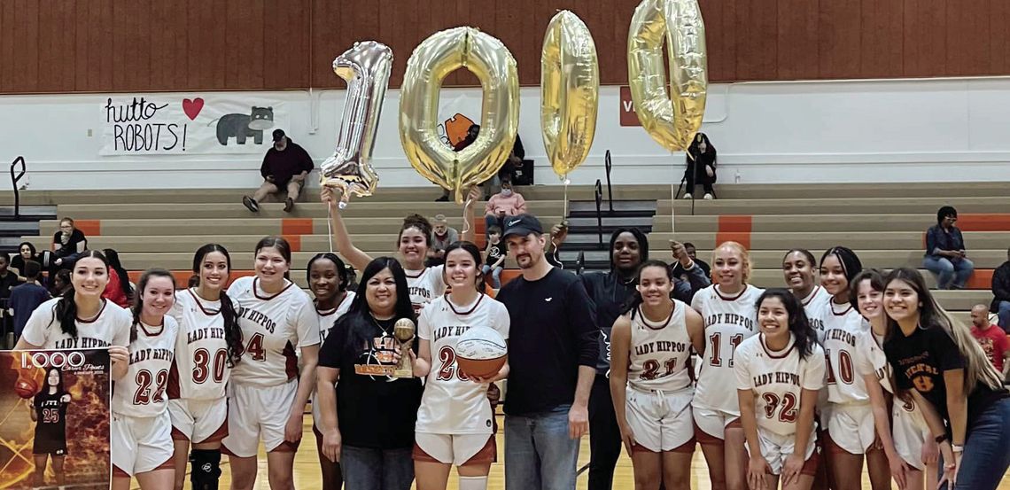 Lady Hippos junior Alyssa Batton posing with her teammates after the game to celebrate her 1,000th career point. Courtesy Photo Hutto ISD