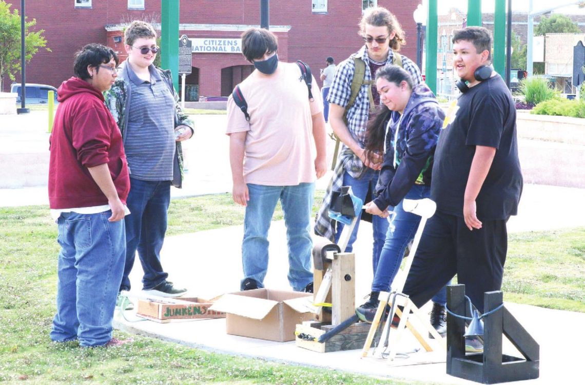 Students from physics classes and robotics classes at Legacy Early College High School team up to launch the catapults they designed and built to learn about projectile motion. Photo by Tim Crow