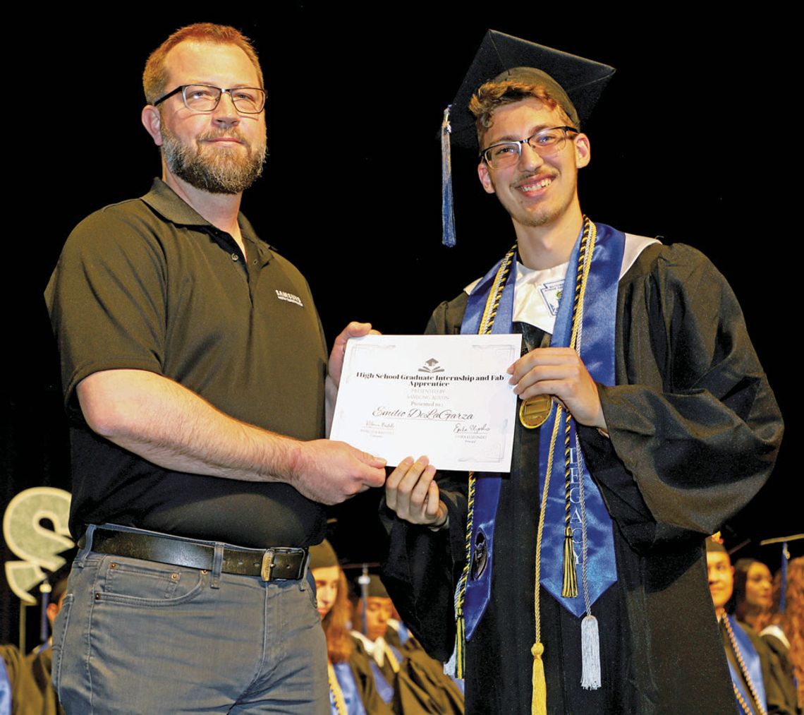 Emilio DeLaGarza, a 2023 Legacy Early College High School graduate, is awarded a post graduate internship at Samsung during graduation ceremonies in May. Making the presentation is Mike Stebbins from Samsung. Photo by Tim Crow