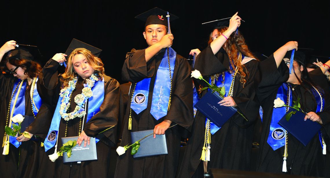 Legacy graduates move their tassels from right to left after receiving diplomas. Photo by Tim Crow