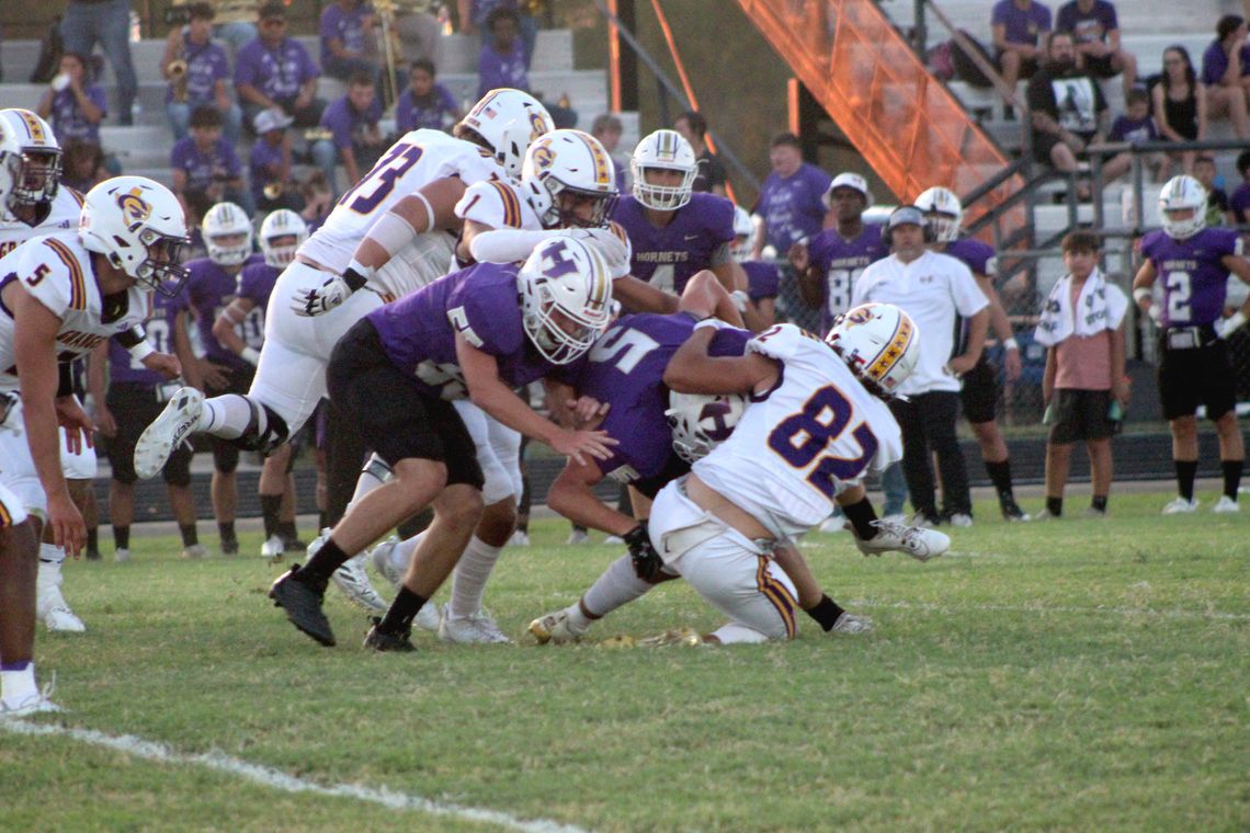 Granger High School varsity football senior outside line backer Thomas Youngblood (82) brings down an opposing ball carrier for a loss of yardage on Friday, Sept. 8 during the Lions’ road game at Holland High School. Photo by Andrew Salmi