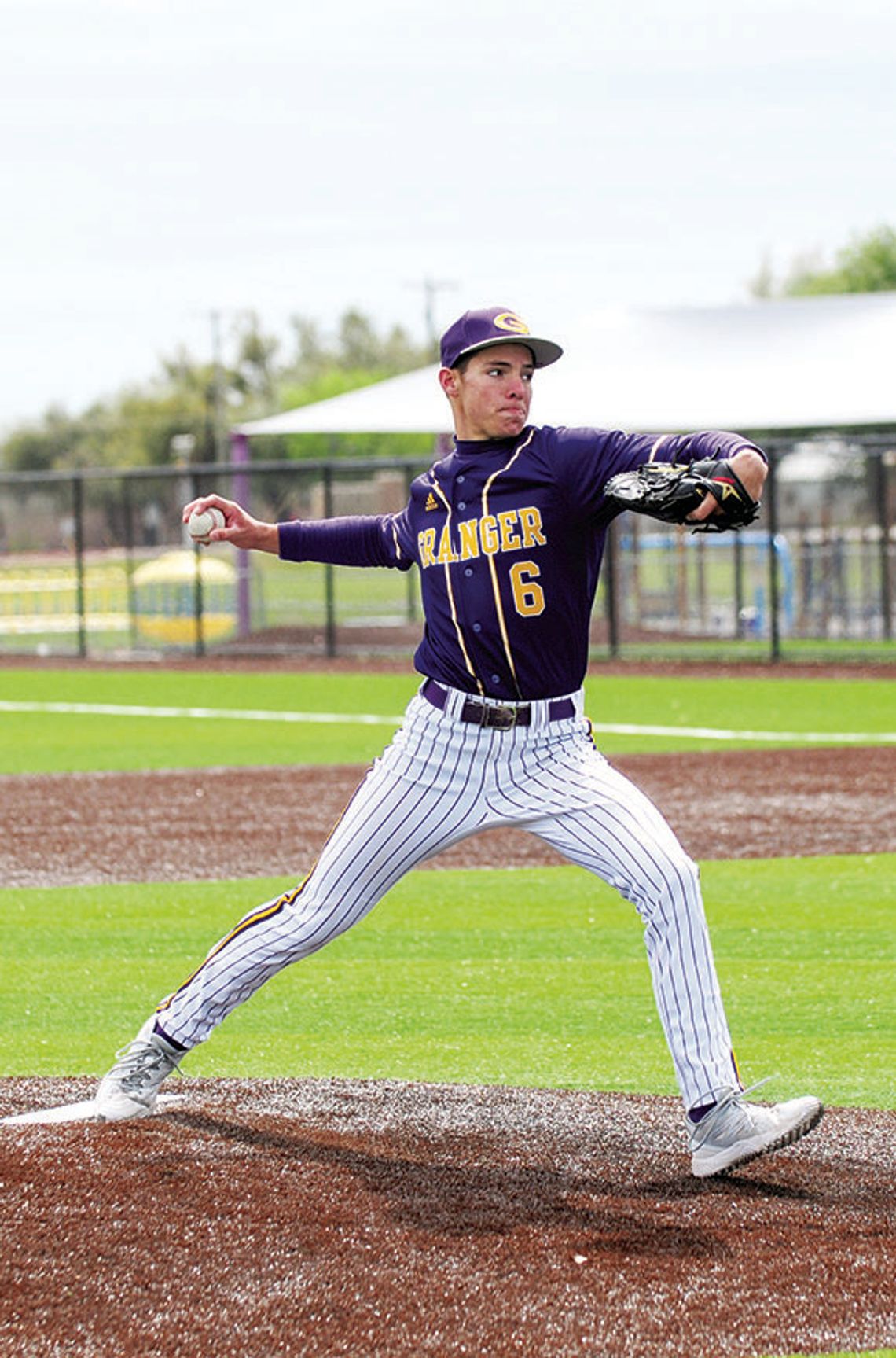 Lions senior Travis Burton delivering a strike to the Thrall batter. Photo by Larry Pelchat