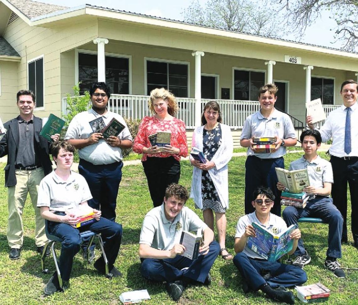 Last year, St. Mary’s Catholic High School faculty and students Gage Garsee, Josh Martinez, Kaedin Hamner, Alex Gauna, Brady Altman, Daniel Vincent, Patrick Heyl, Paula Nemec and John Baker display their new books. File photo