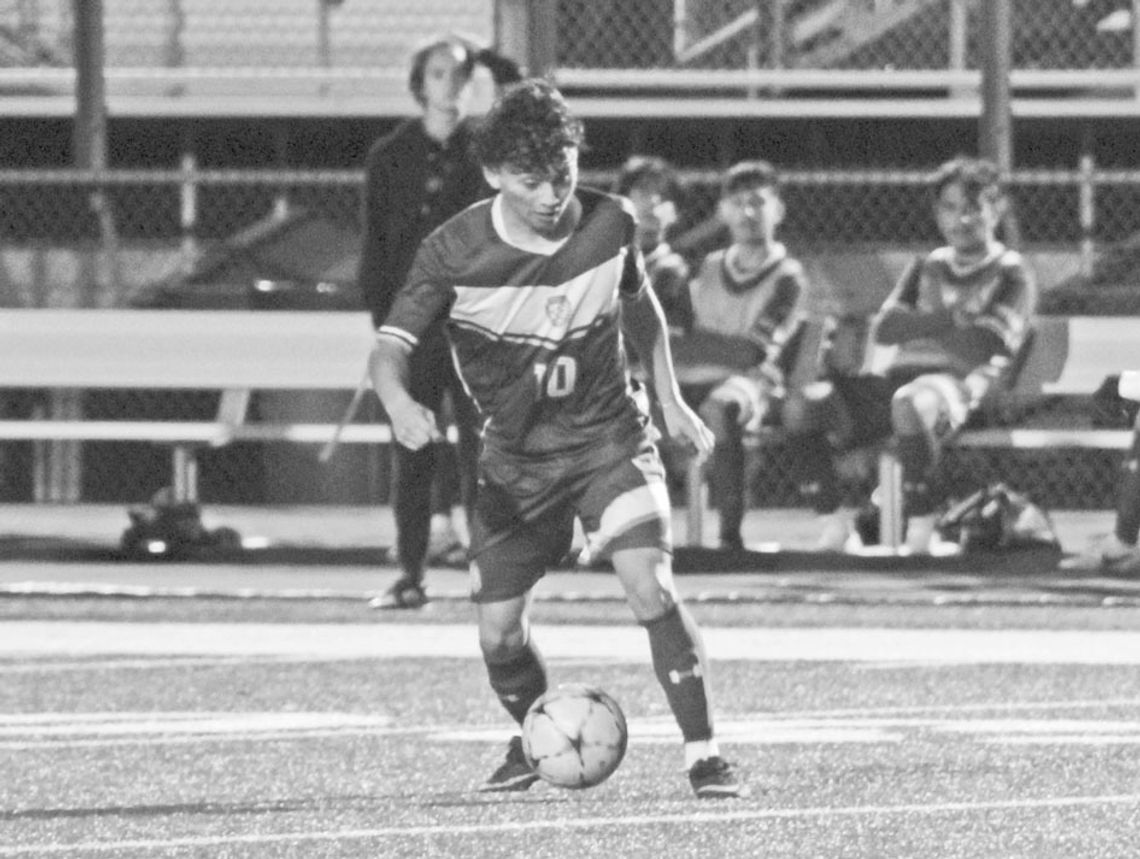 Ducks senior Ivan Aguilar dribbling the ball has defenders close in on him. Photo by Evan Hale