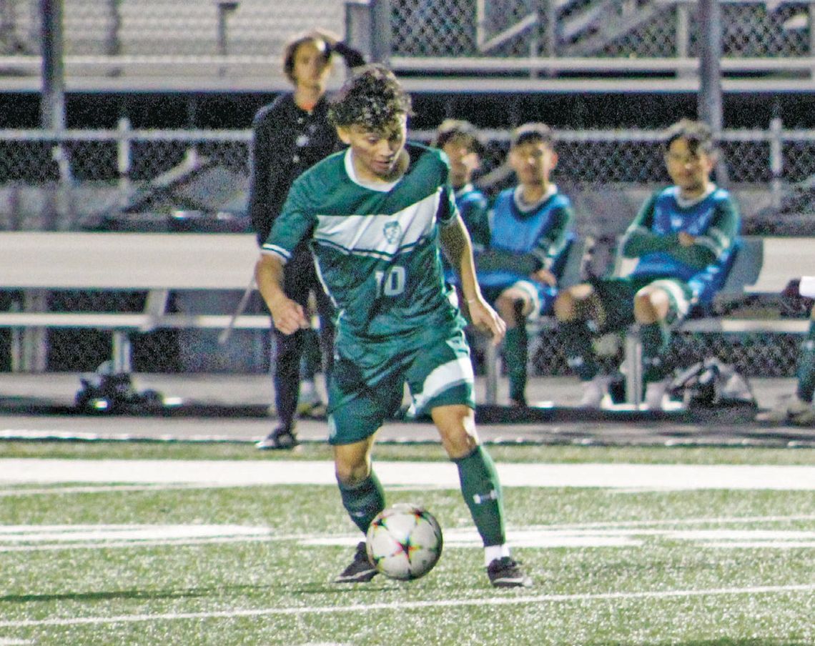 Ducks senior Ivan Aguilar dribbling the ball has defenders close in on him. Photo by Evan Hale