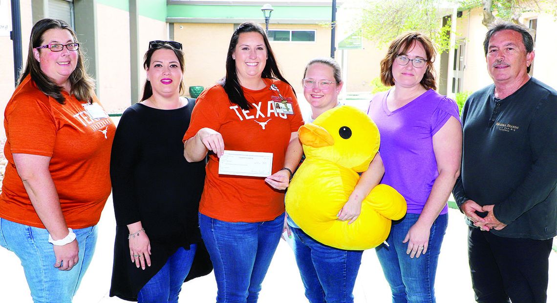 Representatives from the new nonprofit, Mama Duck, present a check to representatives from Taylor ISD Child Nutrition to clear all current student lunch debt. From left are child nutrition personnel Holly O’Briant, Angelica Cazalas, Lindsey Gage, and Mama Duck representatives Desiree Grady...