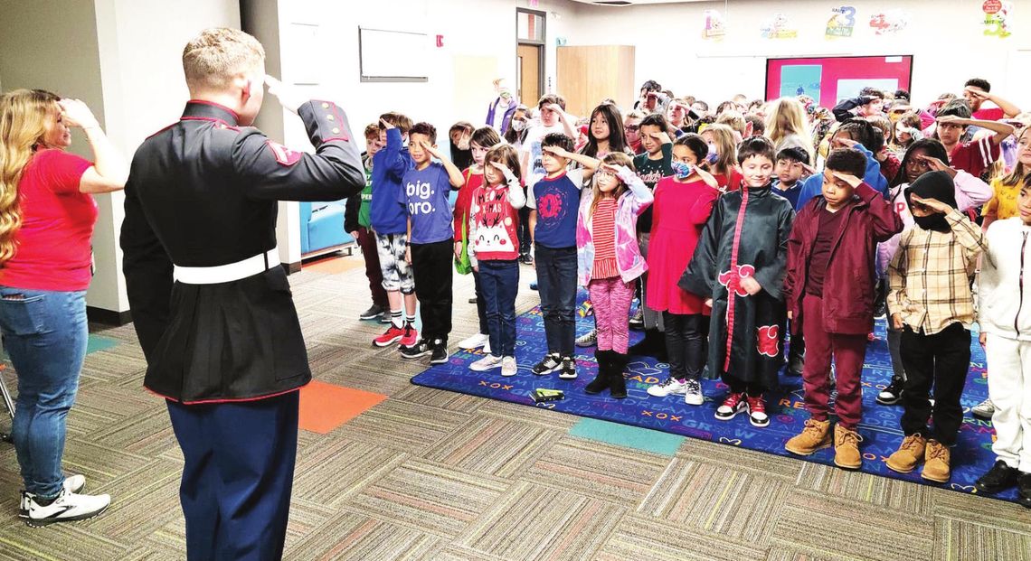 Lance Corporal Noah Goertz does a shared salute with students at the Howard Norman Elementary School during his visit last week. Photos courtesy of the Hutto ISD Facebook page