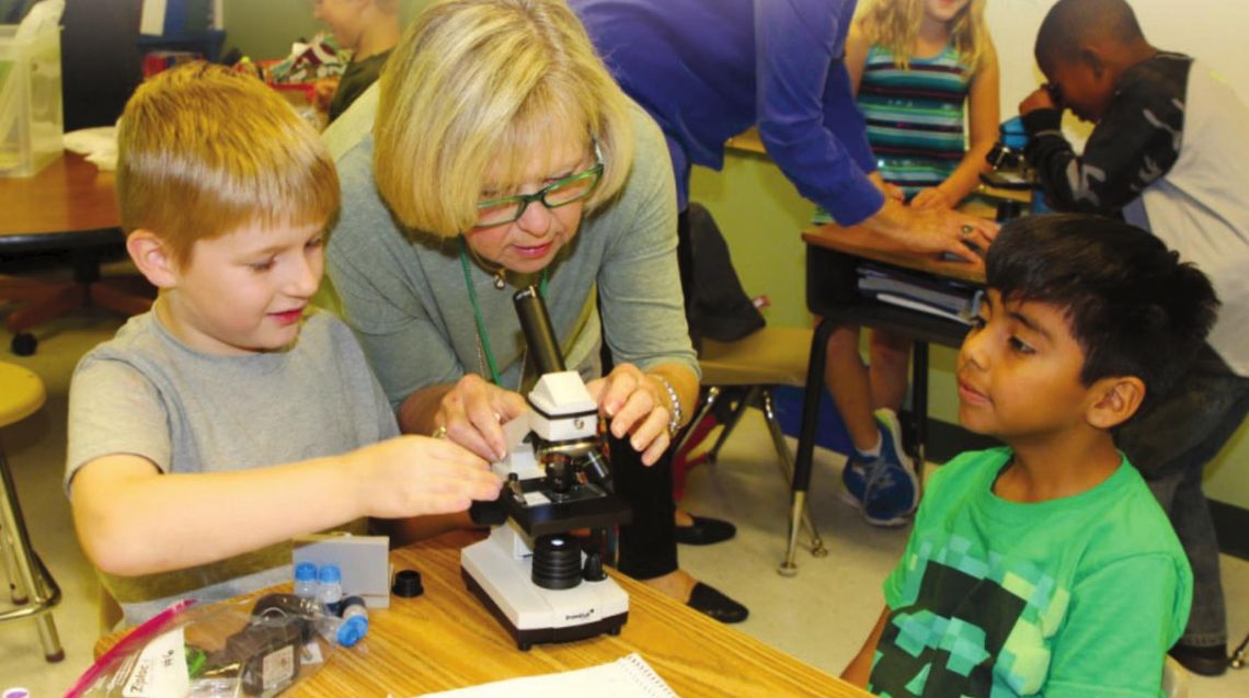 A career of giving back Moppy Miller joins a second grade class at Naomi Pasemann Elementary School in Taylor in 2016 for their first lesson with microscopes, a project that was funded by a TEE Foundation grant. Photos by Tim Crow