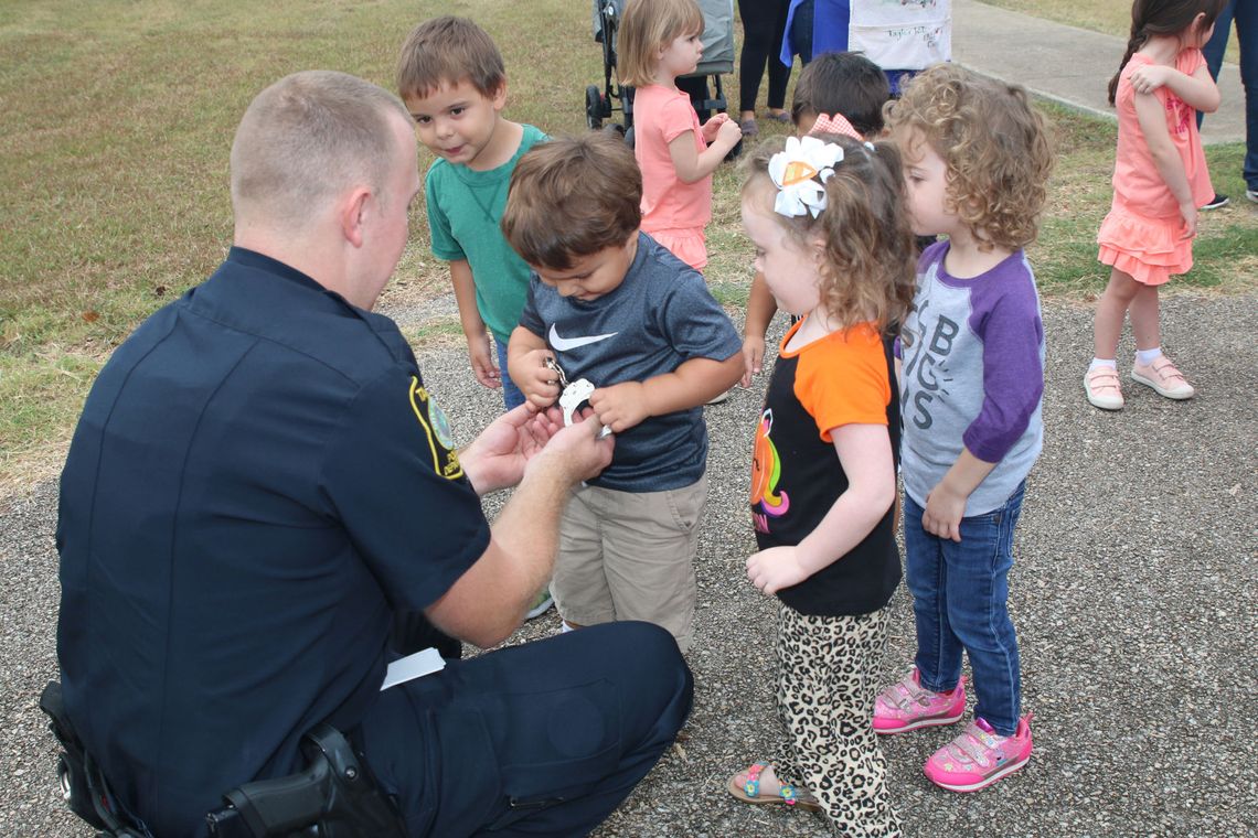 Taylor ISD school resource officer Jacob Loeve visits with students at the district’s child development center about his job in this October 2019 photo.  Photo by Tim Crow