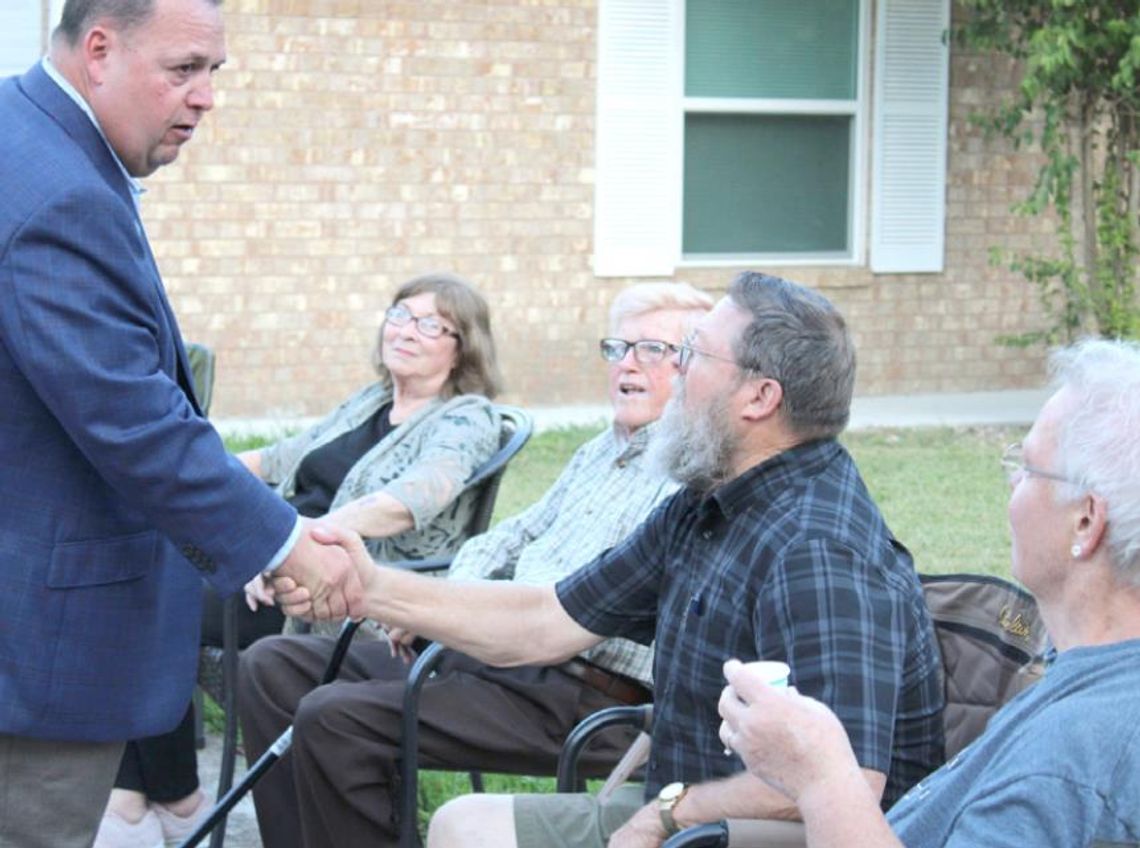 In 2019, Constable Precinct 4 hopeful Paul Leal (left) greets community members while visiting a block party for National Night Out. The event returns after two years Tuesday, Oct. 4. File photo