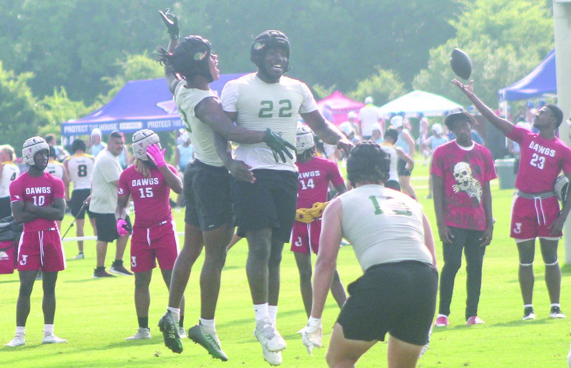 Taylor High School varsity football senior linebacker Alejandro Randle (center) celebrates with junior cornerback Ethan Flagg (left) and senior linebacker Jaden Rush (right) on June 22 during the Ducks’ 41-26 victory over Jasper High School during the state 7-on-7 tournament at Veterans Pa...