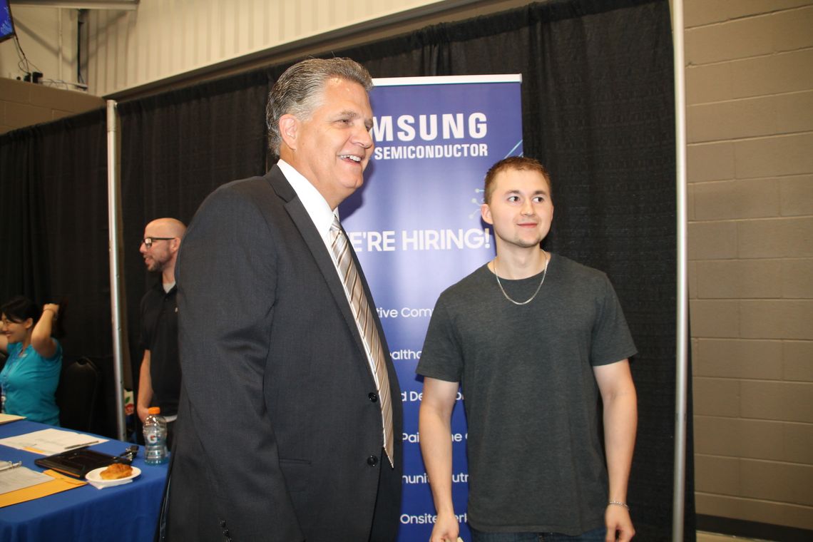 Williamson County Judge Bill Gravell chats with Hutto resident Kyle Spinder, who attended the Samsung Job Fair Sept. 1. Photos by Nicole Lessin