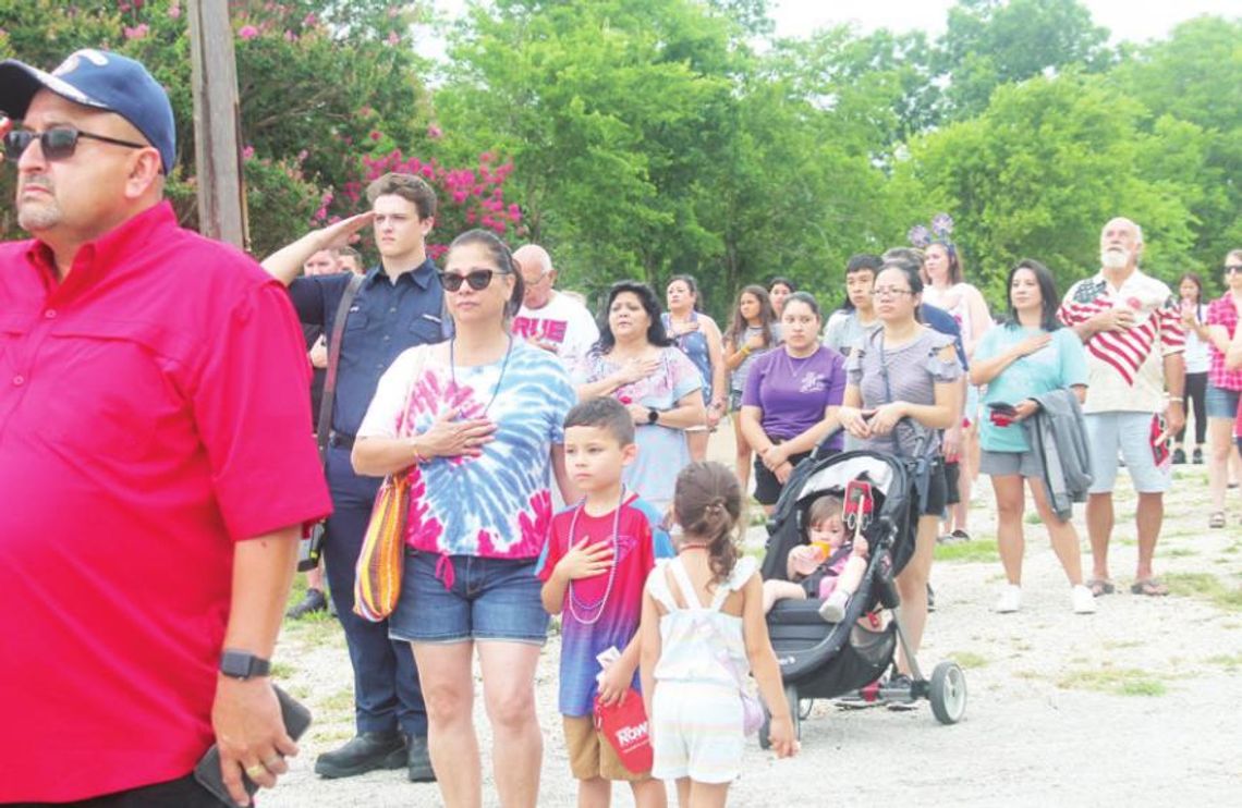 Dwayne Ariola (left) and others stand for the National Anthem at Independence Day festivities at Murphy Park in Taylor July 4, 2021. Photo by Fernando Castro