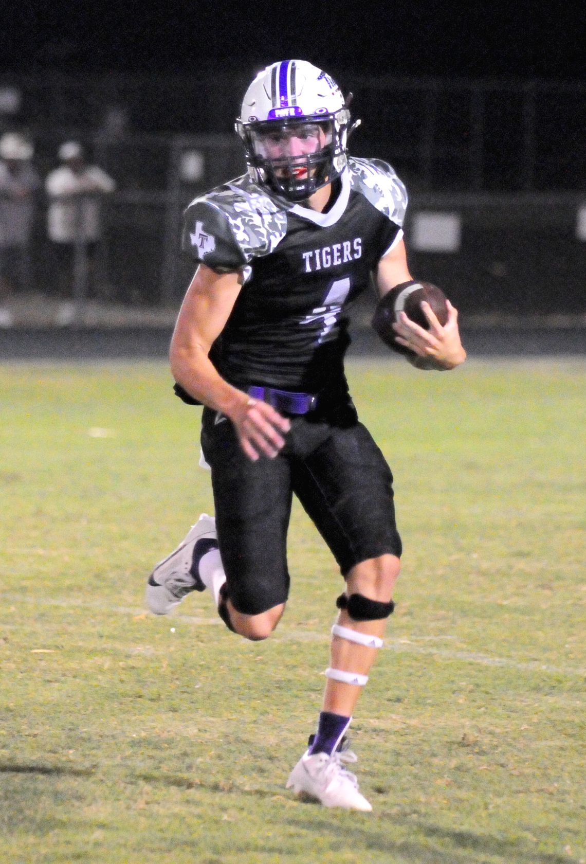 Thrall High School varsity football junior quarterback Chance Parker scrambles for yardage on Friday night during the Tigers’ 56-42 victory at home vs. Johnson City High School.  Photo by Larry Pelchat