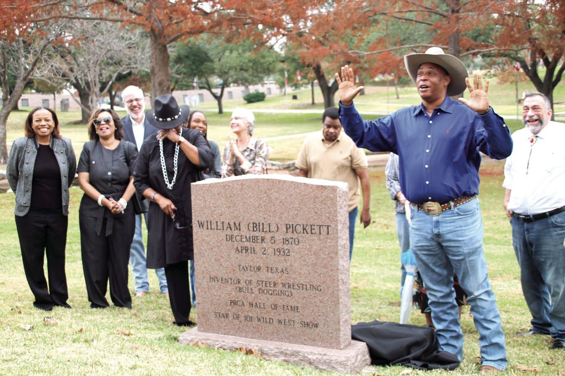 (Front row, from left) Ursurla Williams, Michelle Anderson, Dannie Royal, (back row from left) Mayor Brandt Rydell, Nekoya Anderson, Nancy Hill, Leroy Anderson and Mike Kaspar listen as District 1 Councilman Gerald Anderson addresses the crowd during the unveiling of the Bill Pickett cenot...