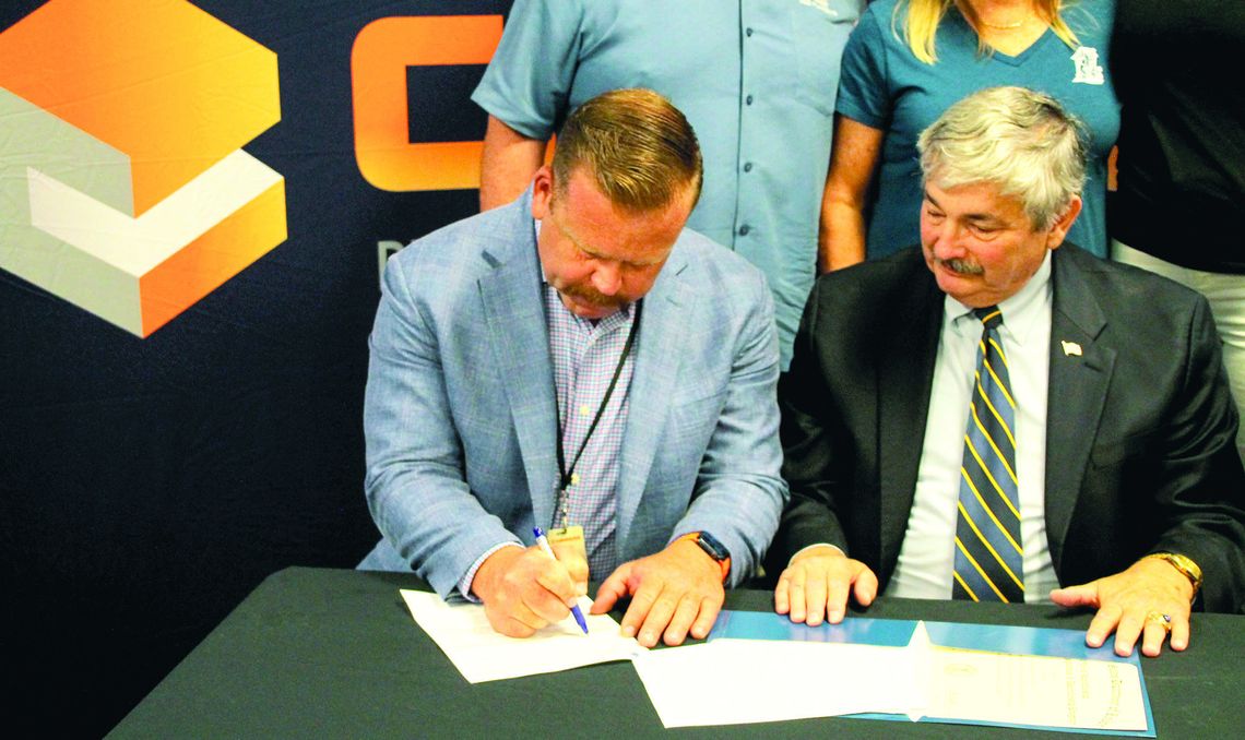 Sam Dowdy Jr. (left), owner and operator for Coppera Plumbing and Commercial Services, signs apprenticeship agreement next to Lee Price (right) of the Department of Labor. Photos by Hunter Dworaczyk